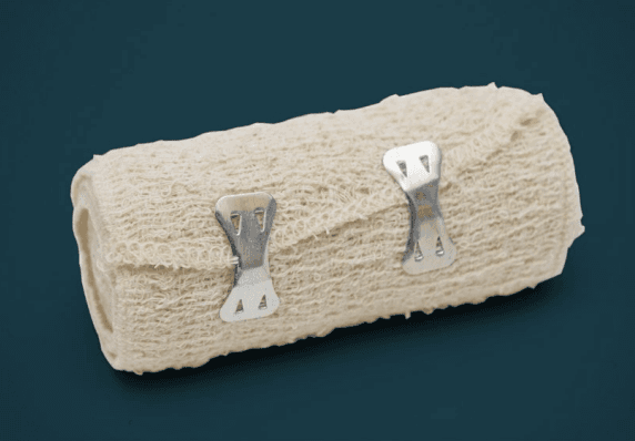 Medical bandage roll with metal clips.