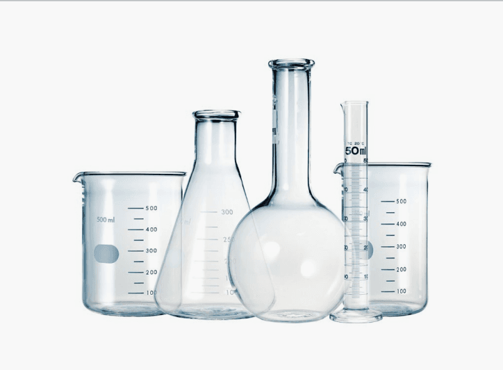 Clear laboratory glassware arranged on a white background.